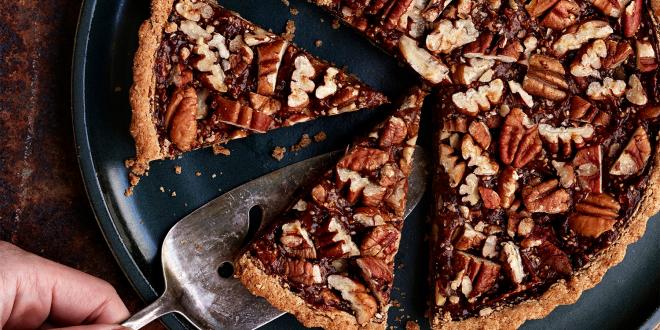 Pumpkin Pecan Tart being sliced and served.